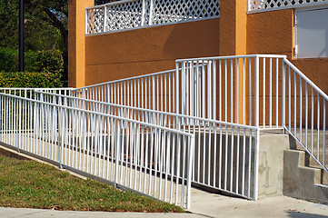 Image showing handicap ramp with white railing and orange wall