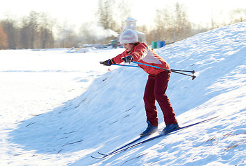 Image showing Girl enjoying cross-country skiing down in sunny day