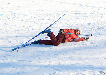 Image showing young beauty girl dropped on snow while skies 