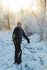 Image showing Boy cross country skiing in forest at sunny winter day