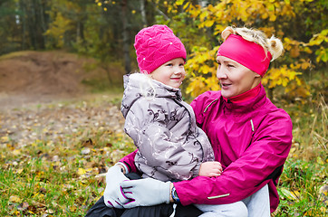 Image showing Grandmother with her granddaughter in the autumn park