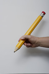 Image showing hand gripping a large pencil 