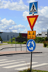 Image showing road signs at intersection roundabout