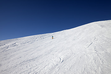 Image showing Skier on slope in sun day