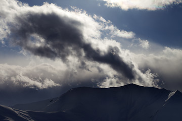 Image showing Evening dark mountain and sunlight clouds