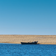 Image showing Solo Rowboat Moored on Sandy Beach