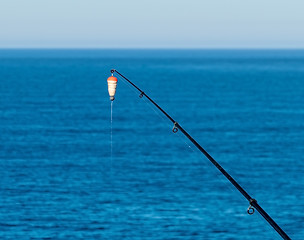 Image showing Fishing Bait-Rod with Float against the Blue Sea Water Surface