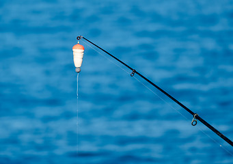 Image showing Fishing Bait-Rod with Float against the Blue Sea Water Surface