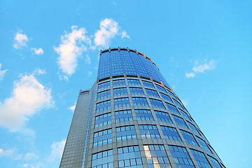 Image showing Office modern building against the evening sky with white clouds