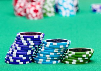 Image showing stack of chips on a green table