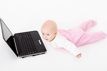 Image showing baby with laptop. studio photo