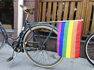 Image showing Rainbow flag on a bicycle.