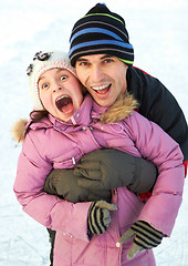 Image showing Dad hug his daughter and have fun in winter park