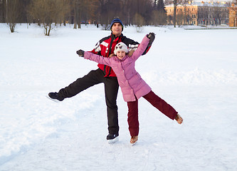 Image showing Happy family on skating rink outdoors