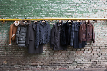 Image showing Men's trendy clothing on hangers