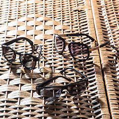 Image showing collection of colorful sunglasses on white background