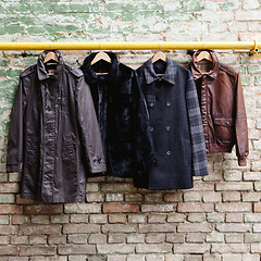 Image showing Men's trendy clothing on hangers