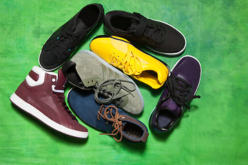 Image showing Set of man footwear on a green background