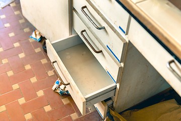 Image showing Cupboard with opened empty drawer