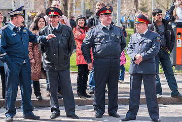 Image showing Four policemen stand in cordon