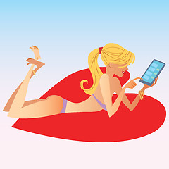 Image showing The blonde girl in swimsuit deals on smartphone