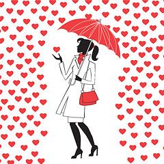 Image showing Woman with umbrella under the rain of red hearts