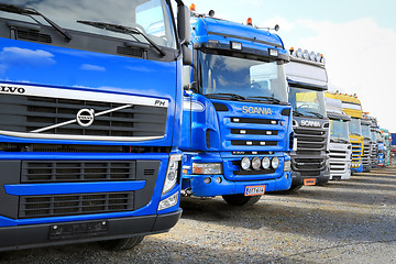 Image showing Row of Colorful Truck Tractors