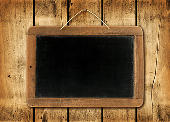 Image showing Blackboard on a wood wall background