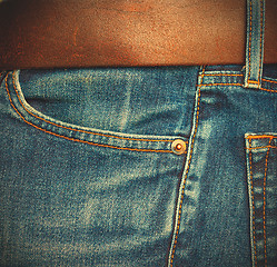 Image showing blue jeans with belt, close up