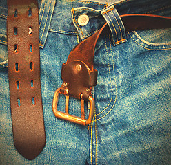 Image showing aged jeans with unfastened belt