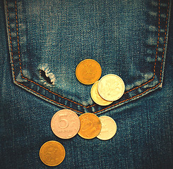 Image showing pocket with hole and coins