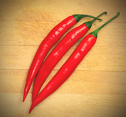 Image showing peppers on the wooden background
