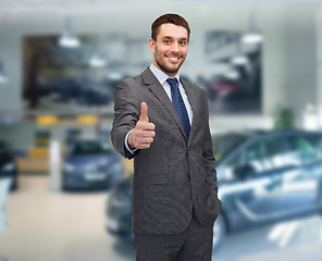 Image showing smiling businessman showing thumbs up