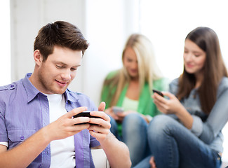 Image showing students looking into devices at school