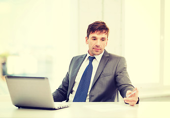 Image showing businessman with laptop computer and documents