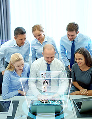 Image showing smiling business people with laptop in office