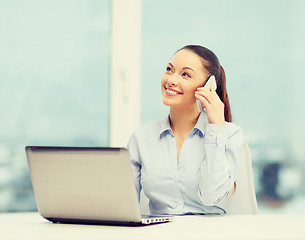 Image showing smiling businesswoman with laptop