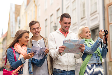 Image showing group of friends with city guide, map and camera