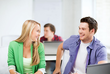Image showing smiling students looking at each other at school