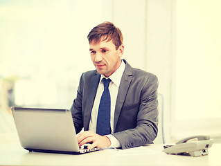 Image showing businessman with laptop computer and documents