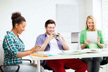 Image showing students looking into devices at school