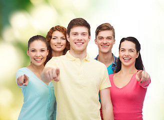 Image showing group of smiling teenagers over green background