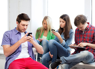 Image showing students looking into devices at school