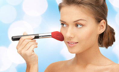 Image showing beautiful smiling woman with make up brush