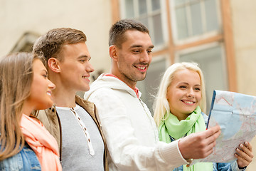 Image showing group of friends with map exploring city