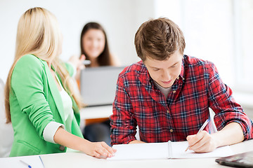 Image showing students writing something at school