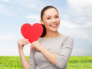 Image showing smiling asian woman with red heart