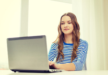 Image showing smiling teenage gitl with laptop computer at home