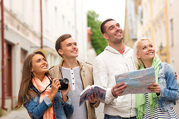 Image showing group of friends with city guide, map and camera