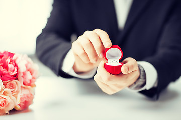 Image showing man with gift box and wedding ring